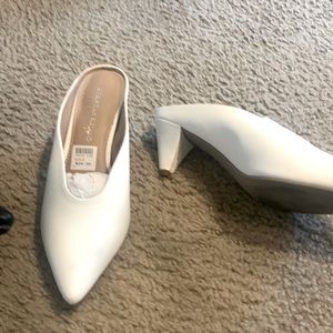 A pair of black and a pair of white closed toe mules. That is $15 each pair.
